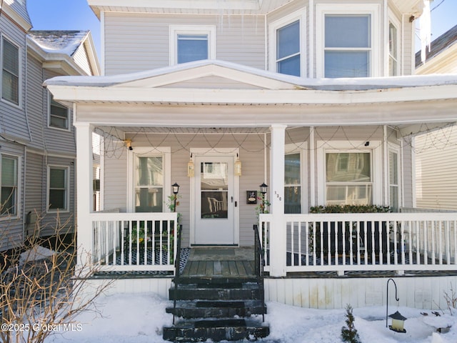 view of snow covered property entrance