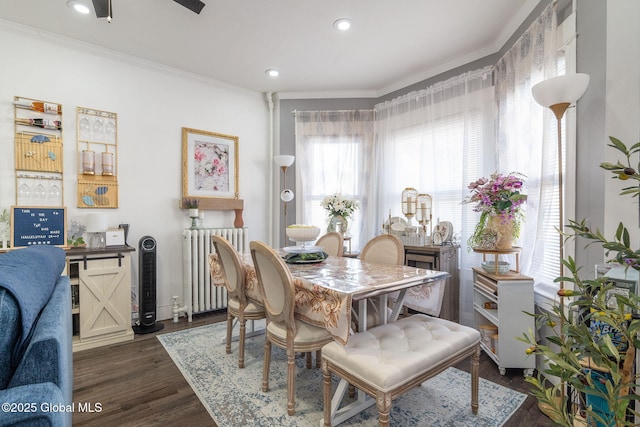 dining space with dark wood-style flooring, ornamental molding, radiator heating unit, and recessed lighting