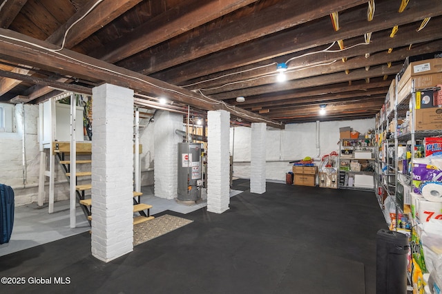 unfinished basement featuring water heater