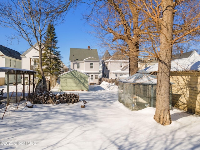 yard covered in snow with a residential view and an outbuilding