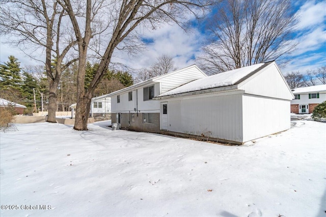 view of snow covered back of property