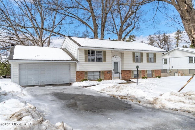 bi-level home with brick siding and an attached garage