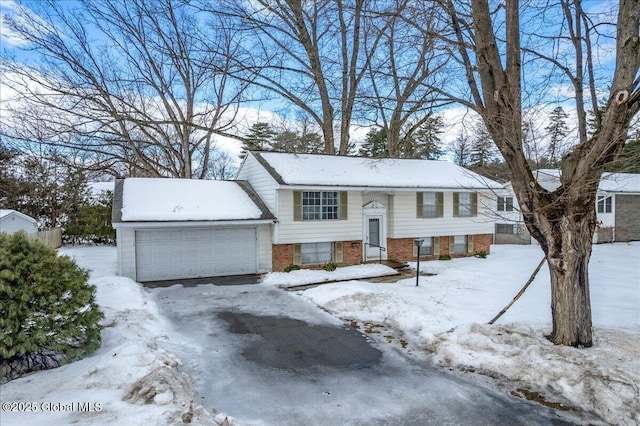 bi-level home featuring brick siding and an attached garage