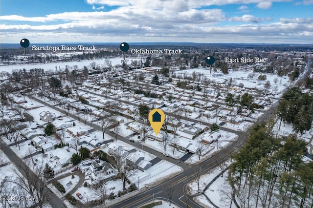 snowy aerial view featuring a residential view