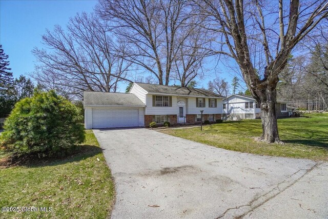 4 Iroquois Dr, Saratoga Springs, NY 12866 - bi-level home with driveway, brick siding, a front lawn, and a garage