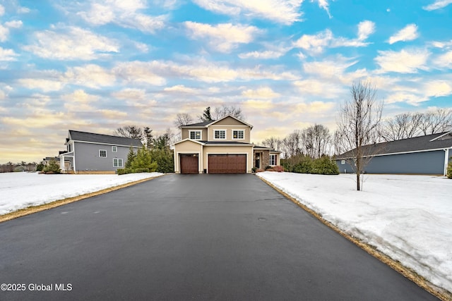 view of front of property with aphalt driveway and an attached garage