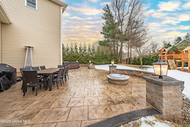 view of patio / terrace with grilling area, a playground, and outdoor dining space