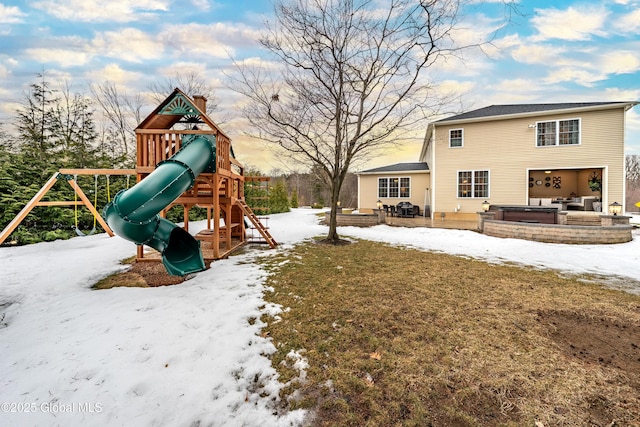 snow covered playground featuring a playground