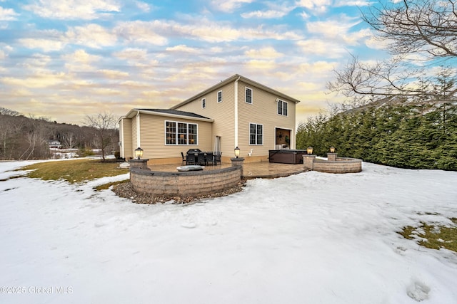 snow covered house with an outdoor hangout area and a patio