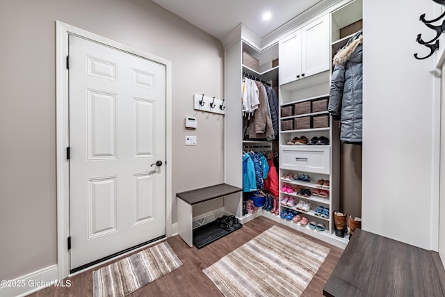 mudroom with wood finished floors and baseboards