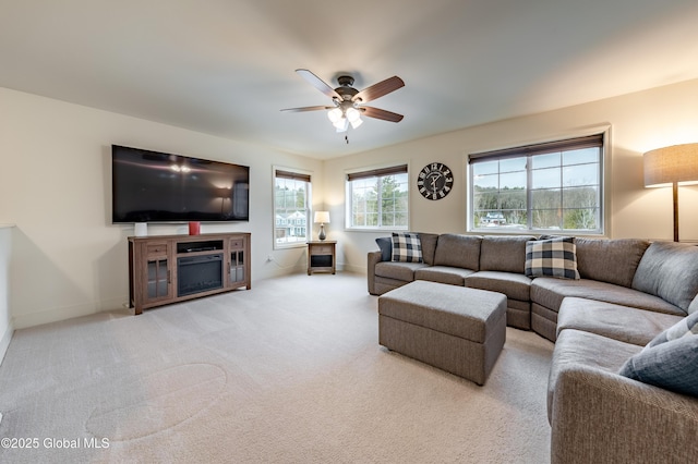 living room with carpet floors, ceiling fan, and baseboards