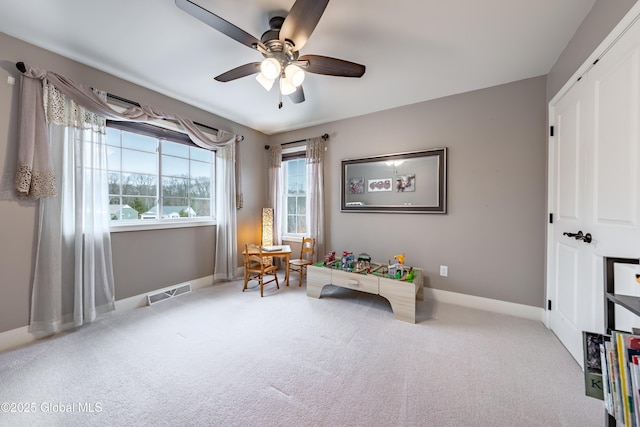 interior space featuring carpet, visible vents, ceiling fan, and baseboards