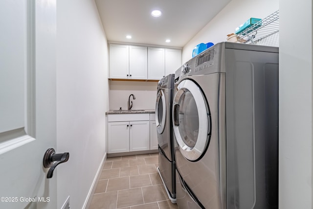 washroom featuring light tile patterned floors, baseboards, washer and clothes dryer, a sink, and recessed lighting