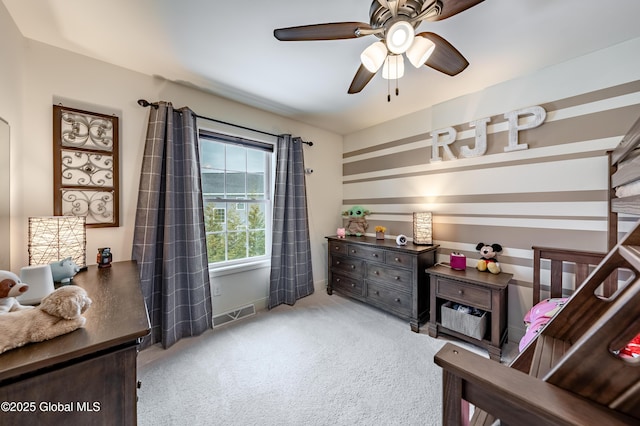 carpeted bedroom with ceiling fan and visible vents