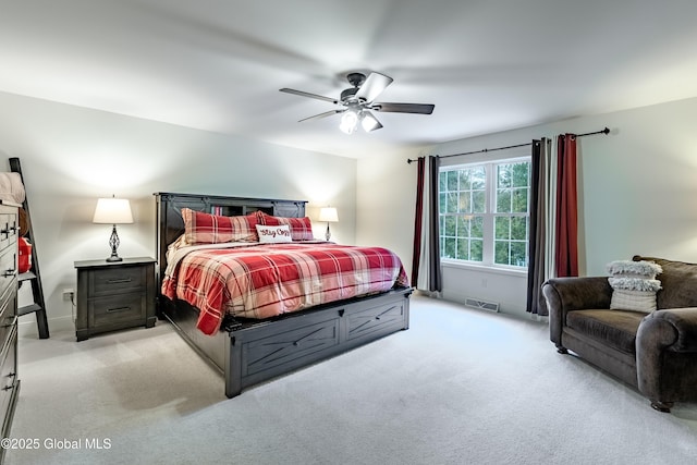 carpeted bedroom featuring visible vents and a ceiling fan