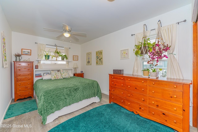 bedroom with ceiling fan and wood-type flooring