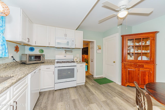 kitchen featuring white appliances, light hardwood / wood-style floors, and white cabinetry