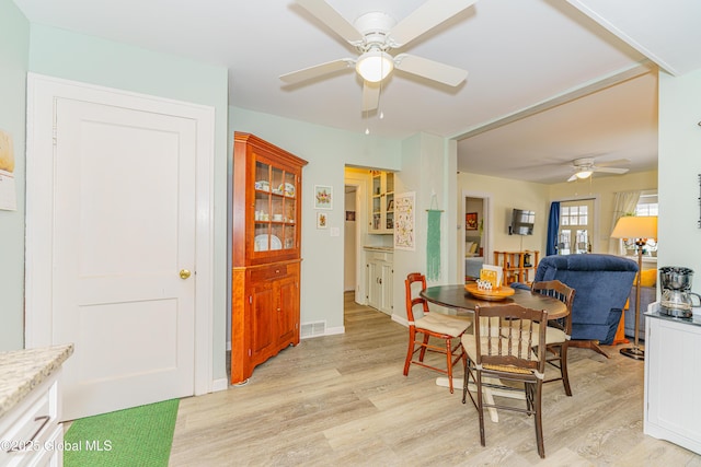 dining area with ceiling fan and light hardwood / wood-style floors