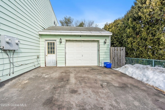 garage with driveway and fence