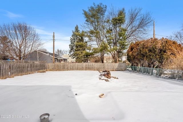 yard layered in snow with fence