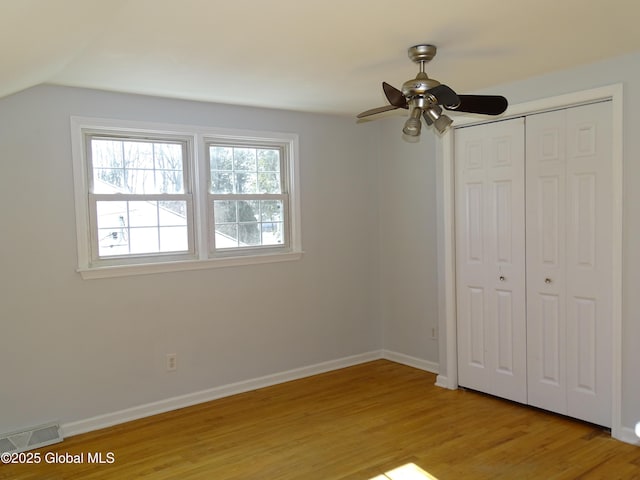 unfurnished bedroom featuring light wood-style floors, a closet, visible vents, and baseboards