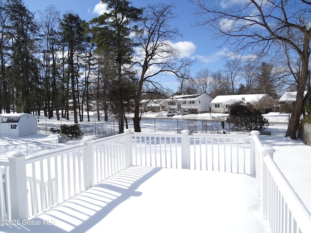 yard layered in snow with a residential view