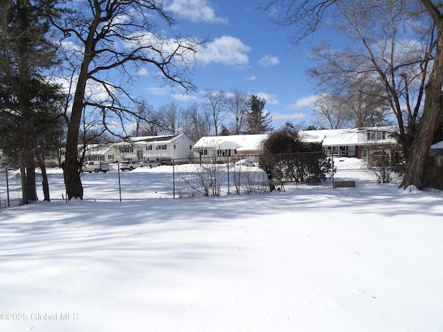 yard covered in snow featuring a residential view