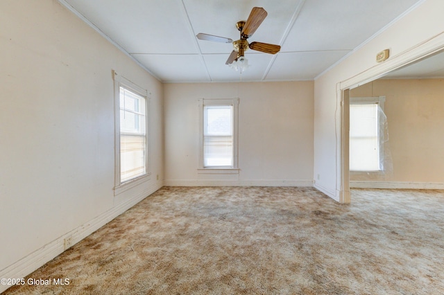 carpeted empty room featuring a ceiling fan