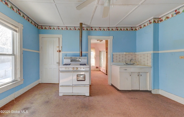 kitchen with light carpet, light countertops, a sink, and double oven range