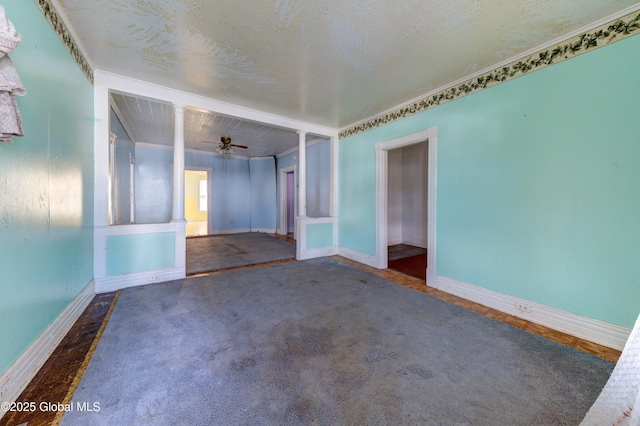 unfurnished room with ceiling fan and baseboards