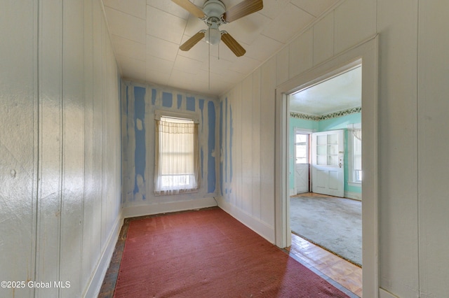 spare room with carpet flooring, a ceiling fan, and baseboards