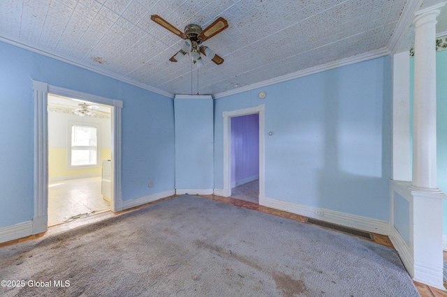 empty room with visible vents, baseboards, a ceiling fan, ornamental molding, and ornate columns