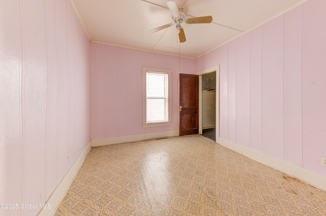 empty room with ceiling fan and ornamental molding