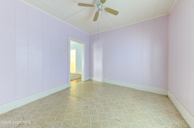 unfurnished room with baseboards, ornamental molding, a ceiling fan, and tile patterned floors