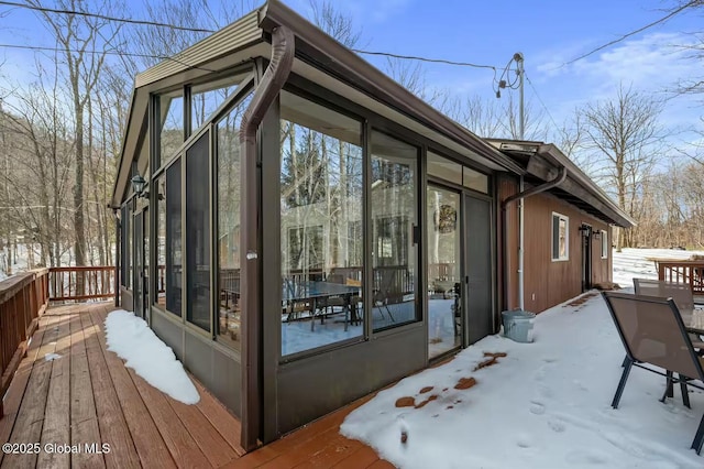 exterior space with a wooden deck and a sunroom