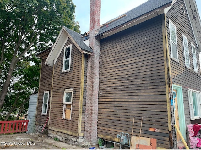 view of property exterior featuring a chimney