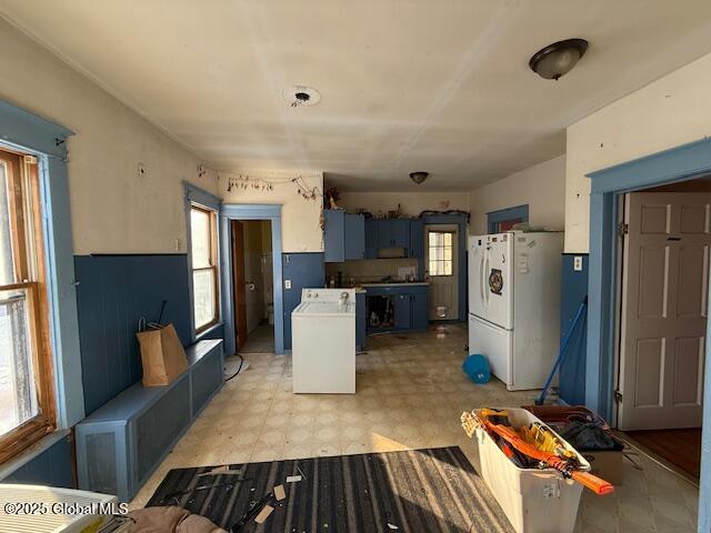 kitchen featuring blue cabinets and white refrigerator