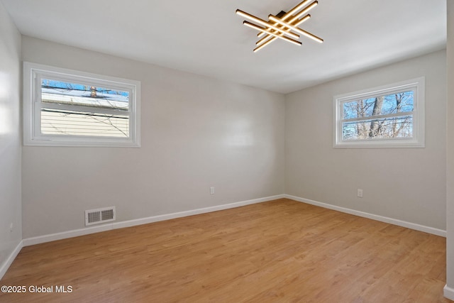 interior space featuring light wood finished floors, visible vents, and baseboards