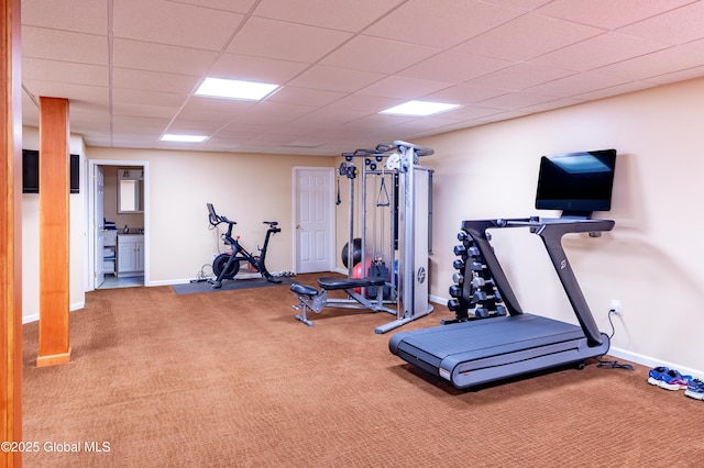 workout room with carpet floors, a drop ceiling, and baseboards