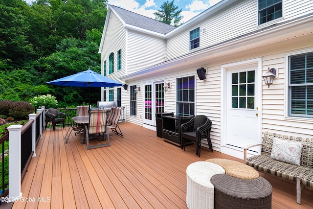 wooden terrace featuring outdoor dining area