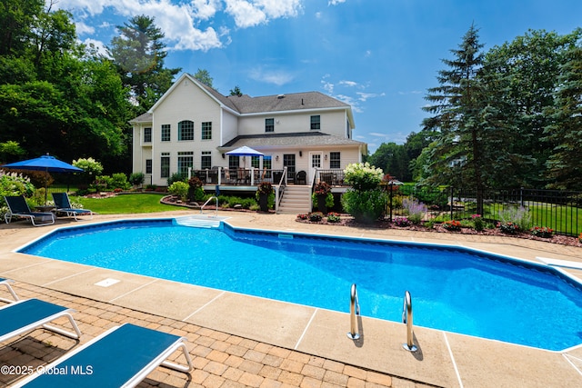 view of pool with a deck, fence, stairway, a fenced in pool, and a patio area