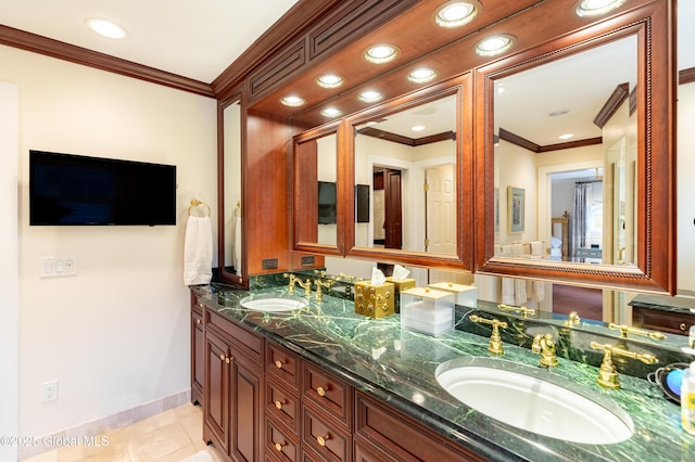 bathroom with double vanity, tile patterned flooring, ornamental molding, and a sink