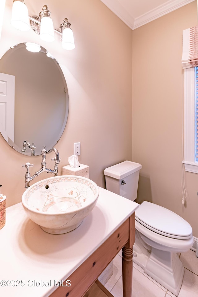 bathroom with ornamental molding, vanity, toilet, and tile patterned floors