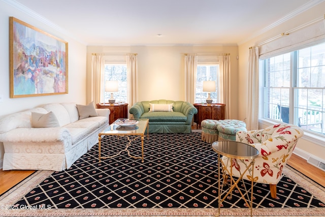 living room with plenty of natural light, visible vents, and crown molding