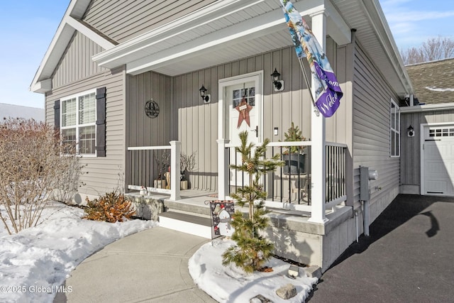 view of exterior entry featuring board and batten siding and covered porch