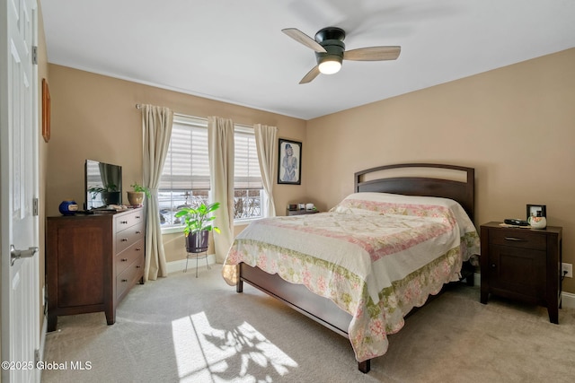 bedroom featuring light carpet, ceiling fan, and baseboards