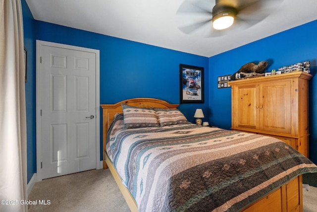 bedroom with a ceiling fan and light colored carpet