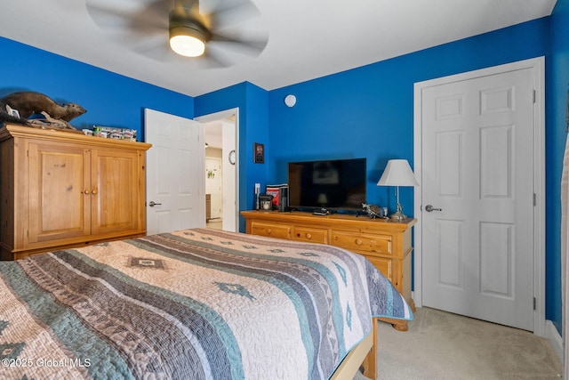 bedroom featuring light colored carpet and ceiling fan