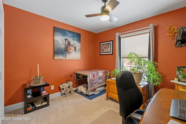 home office with ceiling fan, baseboards, and light colored carpet