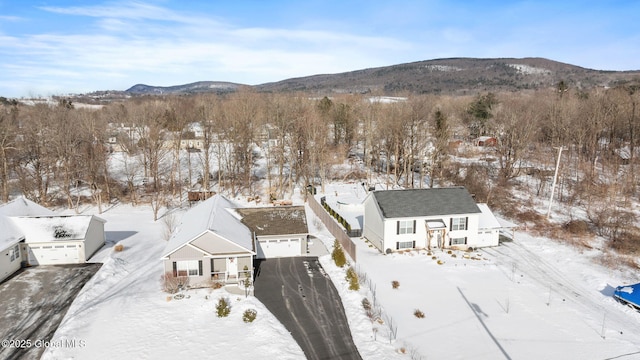 snowy aerial view featuring a mountain view